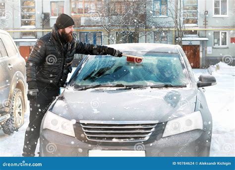 Man Cleans Snow From The Glass At The Car Stock Photo Image Of Brush