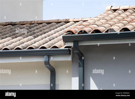 Grey Gutter Guard System Roof Drip Edge On Modern Home Neighborhood