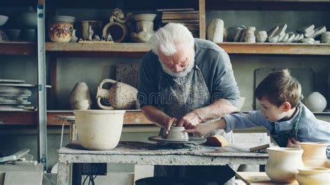 Experienced Male Potter Is Mixing And Kneading Clay While His Cute