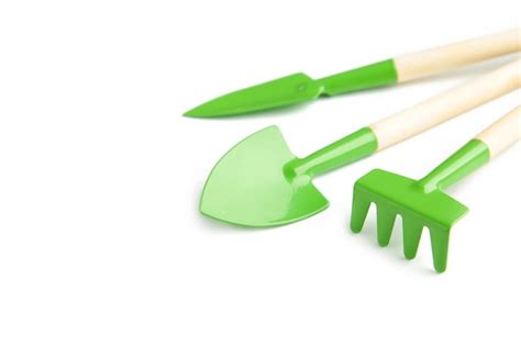 Premium Photo | Green gardening tools isolated on white surface