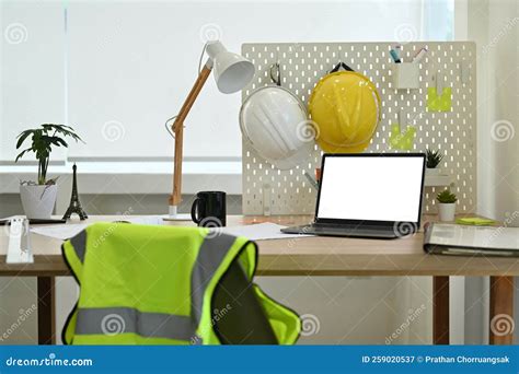 Architect Working Desk with Laptop Computer, Hardhat, Reflective Jacket ...