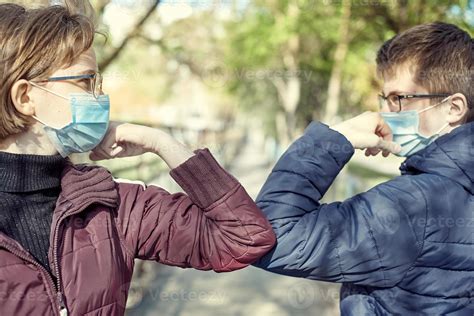 Friends guy and girl demonstrating a new way of greeting during ...