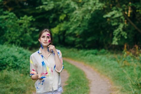 Free Photo | Woman with face and clothes stained paint with pensive face