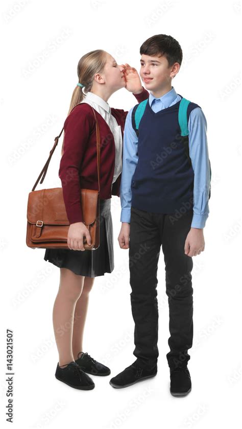 Cute boy and girl in school uniform standing on white background Stock ...