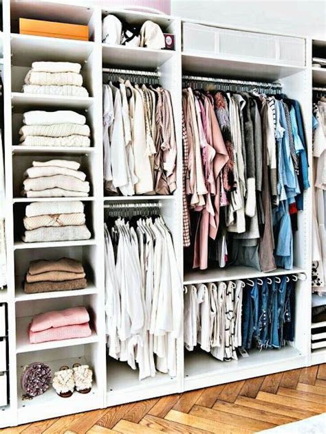 An Organized Closet Filled With Clothes And Folded Shirts