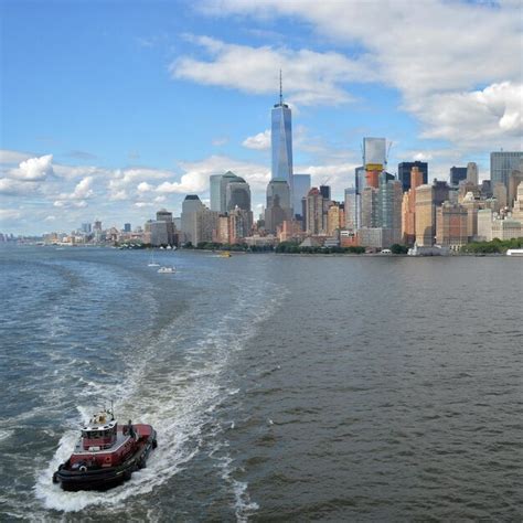 Premium Photo Boats In River With City In Background