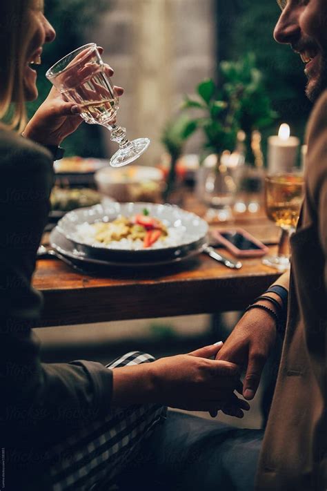 Couple Holding Hands At The Dinner By Stocksy Contributor Lumina