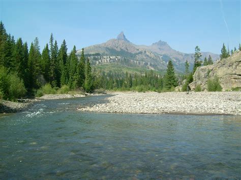 the water is crystal clear and there are mountains in the background ...