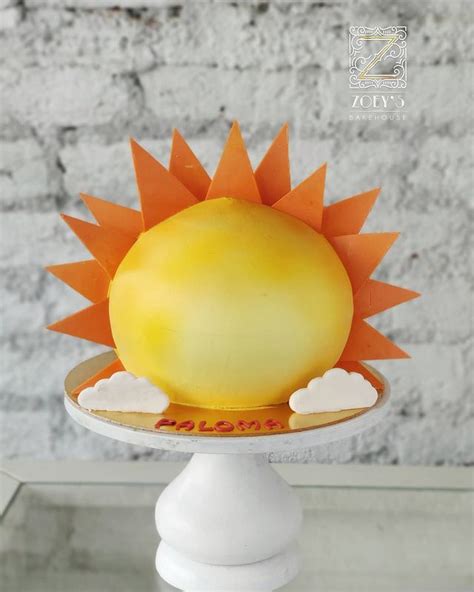 A Yellow Cake With An Orange Sun On Top