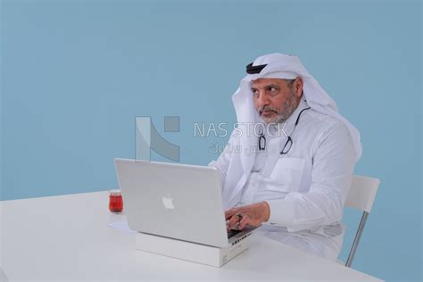 Saudi Man Sitting And Working On A Laptop A Cup Of Tea Business