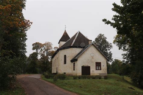 Lutheran Church Among The Yellowing Foliage On The Trees In The Small