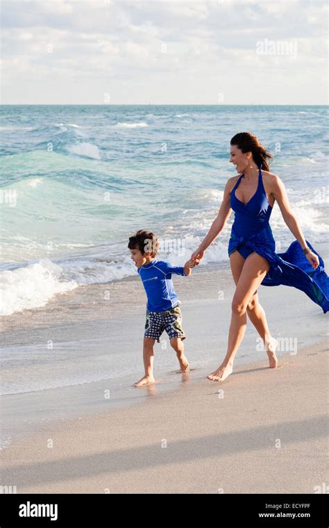 Caucasian Mother And Son Walking On Beach Stock Photo Alamy