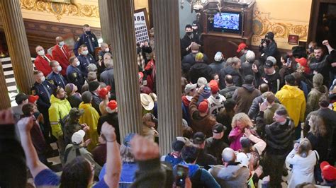 Protesters, some armed, enter Michigan Capitol