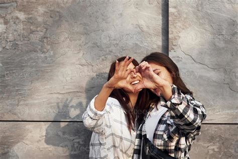 Love Gesture Beautiful Cheerful Friends Or Lesbian Couple Together Near Wall Outdoors At