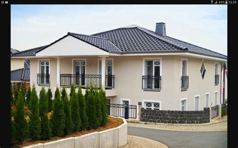 A White House With Black Roof And Windows