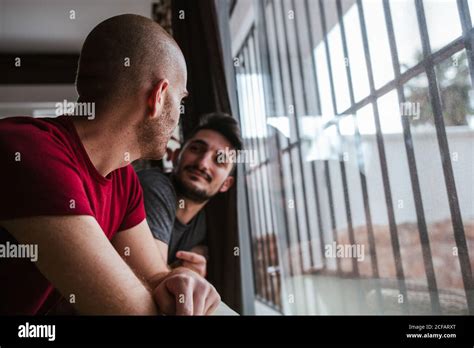 Gay Couple Looks Fondly At The Window Stock Photo Alamy