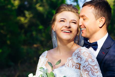 Closeup Of Happy Newlyweds In Each Others Arms And Sweet Smiles Stock