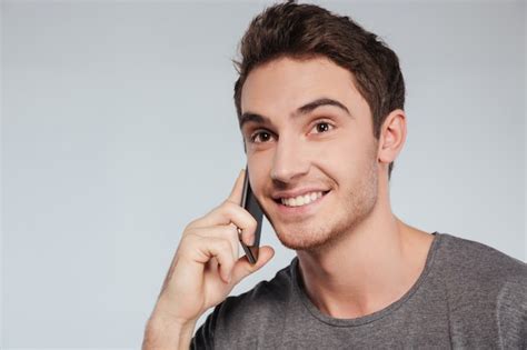 Premium Photo Portrait Of A Smiling Handsome Man Talking On Cell