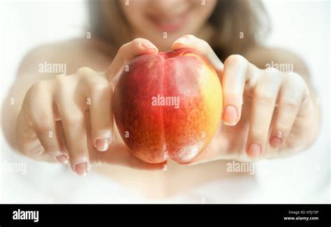 Peach In Female Hands Stock Photo Alamy