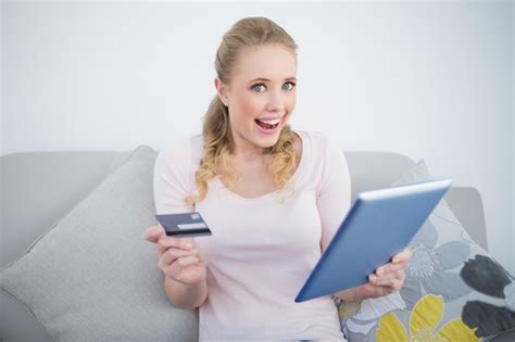 Premium Photo Casual Thrilled Blonde Holding Tablet And Credit Card