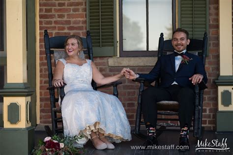 Happy Newlyweds Hold Hands On Rocking Chairs Michiganwedding