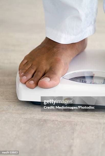 mans feet scale stock  high res pictures  images getty