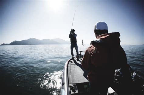 Woman Holding Large Mouth Bass Caught Fishing From Boat Editorial Photo