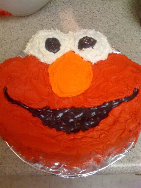 the cake is decorated to look like an orange sesame street character ...