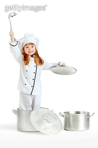 A Little Pretty Girl Dressed As A Kitchen Hand In A Cooking Pot Holding