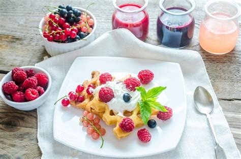 Premium Photo Belgian Waffles With Whipped Cream And Fresh Berries