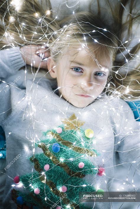 Beautiful Blonde Preteen Girl With Blue Eyes Lying On Bed With