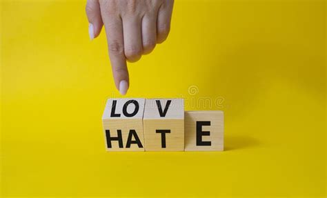 Love Vs Hate Symbol. Businessman Hand Points at Wooden Cubes with Words ...