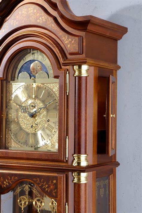 An Antique Grandfather Clock With The Moon Visible