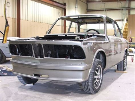 an old car is being worked on in a garage