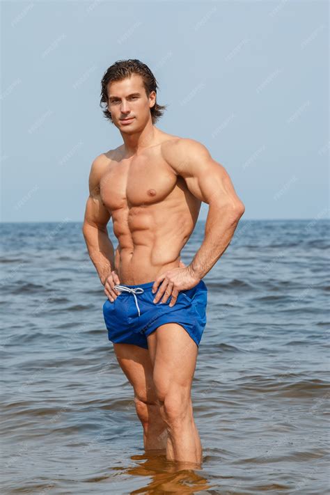 Muscular Man On The Beach Premium Photo
