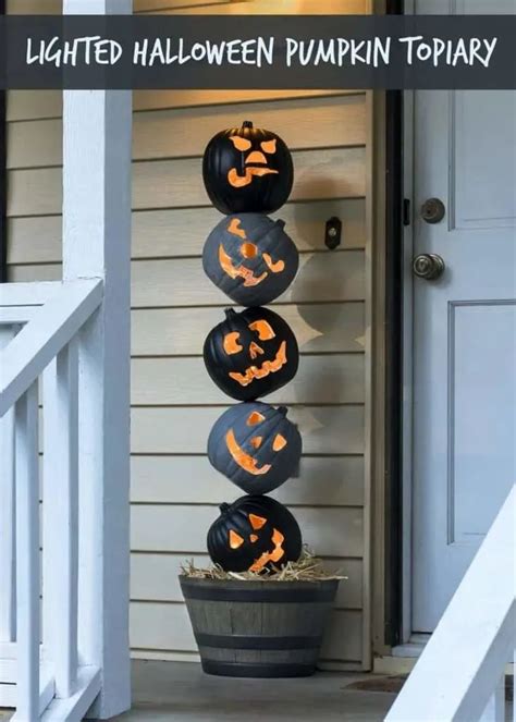 Three Pumpkins Are Stacked On Top Of Each Other In Front Of A House