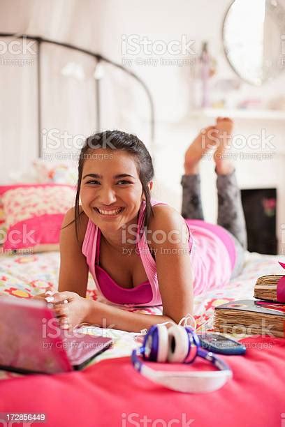 Teenage Girl Laying On Bed Using Laptop Stock Photo Download Image