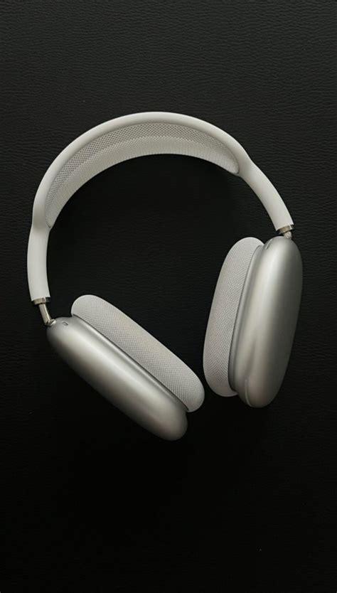 A Pair Of White Headphones Sitting On Top Of A Table Next To Each Other