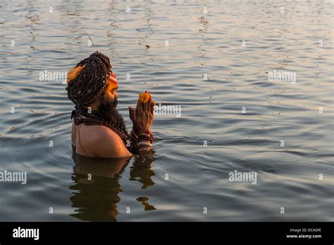 Sadhu Holy Man Taking A Bath And Praying In The Sangam The