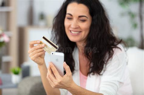 Mature Woman Holding Credit Card While Talking On Mobile Phone Stock Photo Image Of Bank