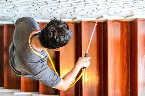 Premium Photo | Asian Thailand termite staff company is spraying the ...