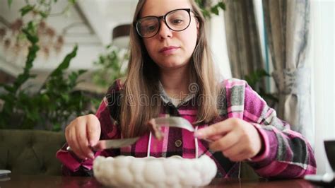 Female Sitting At Table With Plate Of Food A Woman Is Sitting At A