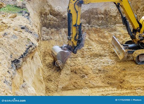 Excavator During Earthworks At Construction Site Backhoe Digging The