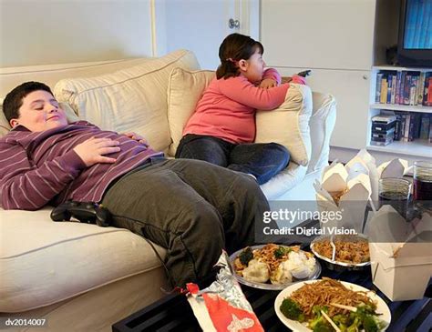 overweight child watching tv stock  high res pictures