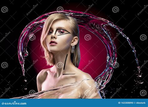 Beautiful Blonde Girl With Naked Shoulders And Avant Garde Conceptual Makeup Surrounded By