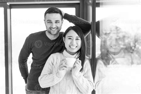 multiethnic couple enjoying morning coffee by the window 31032023 Stock ...