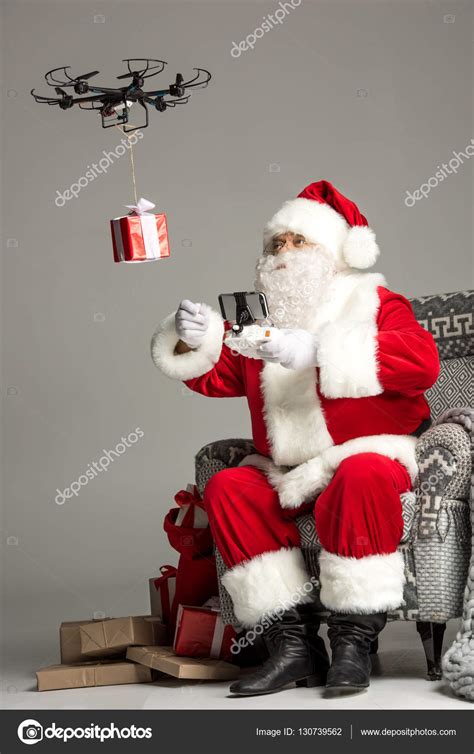 Santa Claus using drone — Stock Photo © ArturVerkhovetskiy #130739562