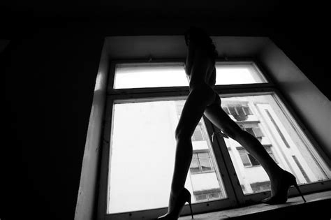 Premium Photo Low Angle View Of Naked Woman Standing On Window Sill At Home