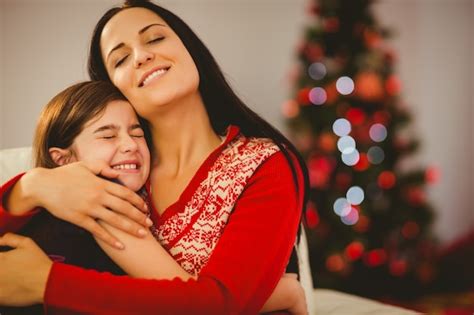 Premium Photo Festive Mother And Daughter Hugging On Couch