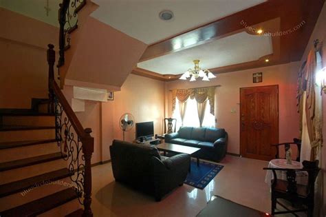 A Living Room Filled With Furniture Next To A Stair Case In A Home S